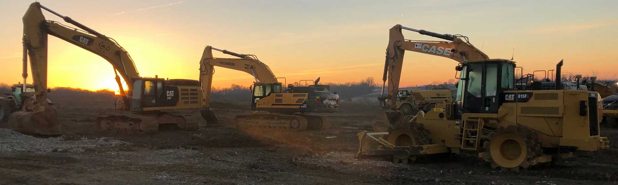 Backhoes at sunset